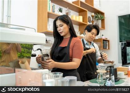 Barista is Making a Cup of Cappuccino in Coffee Shop Bar,Professional barista preparing coffee using chemex pour over coffee maker and drip kettle,Alternative ways of brewing coffee.