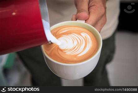 Barista make latte art. Cup of coffee latte in coffee shop