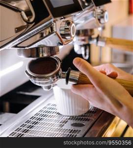 barista makes coffee in a coffee machine
