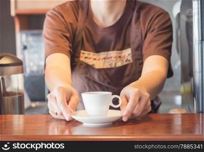 Barista offering mini white cup of coffee, stock photo stock photo