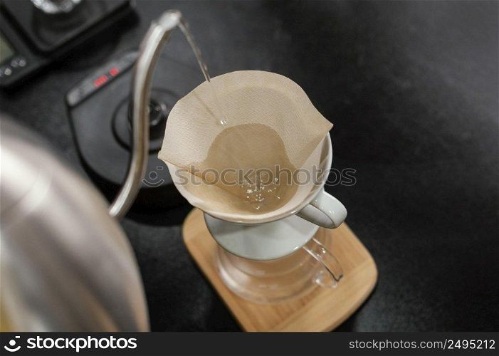 barista pouring boiling water coffee filter