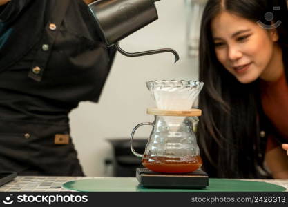 Barista pouring boiling water from kettle to drip coffee maker at the bar of the modern cafe,Entrepreneur business concept banner.