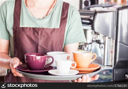 Barista preparing set of freshly brewed coffee for serving, stock photo
