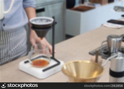 Barista with drip coffee, blurred background or defocus