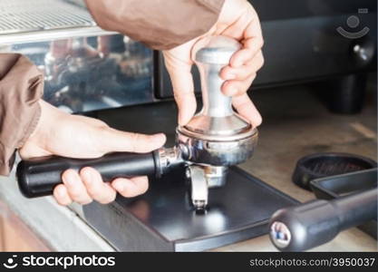 Barista with tamper for making espresso, stock photo