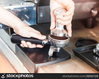 Barista with tamper for making espresso with vintage style, stock photo