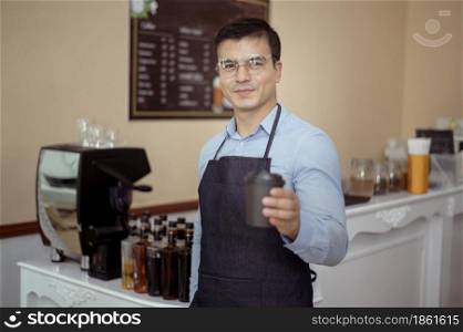 Baristas hand taking cup of hot coffee and bakery to offering to customer in coffee shop