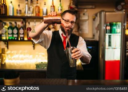 Barkeeper show behind restaurant bar counter. Handsome alcohol beverage preparation. Barkeeper show behind restaurant bar counter