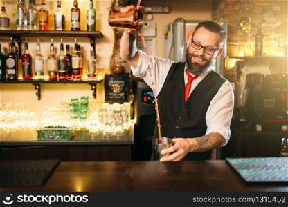 Barkeeper show behind restaurant bar counter. Handsome alcohol beverage preparation