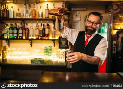Barkeeper show behind restaurant bar counter. Handsome alcohol beverage preparation. Barkeeper show behind restaurant bar counter