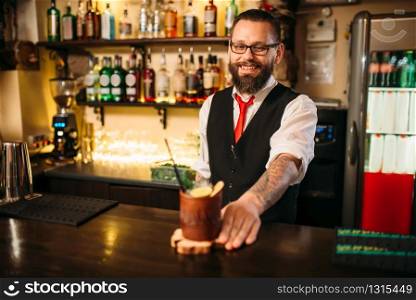 Barkeeper shows attractive alcoholic cocktail. Handsome alcohol beverage preparation. Barkeeper show attractive alcohol cocktail