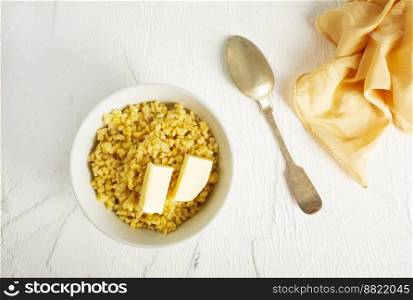 Barley porridge with butter in white bowl