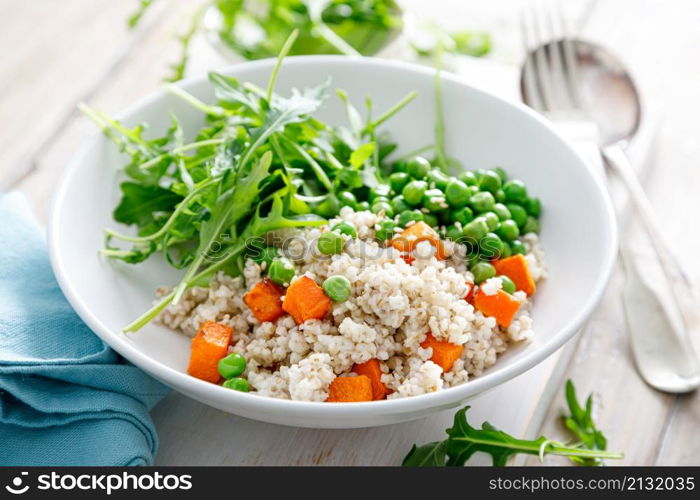 Barley porridge with green peas, baked pumpkin and fresh arugula salad