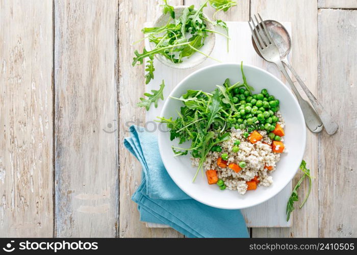 Barley porridge with green peas, baked pumpkin and fresh arugula salad