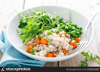 Barley porridge with green peas, baked pumpkin and fresh arugula salad