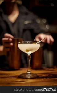 Barman making a martini cocktail at a bar, selective focus . Barman making a martini cocktail at a bar