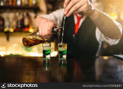 Barman making attractive alcoholic cocktail. Alcohol beverage preparation