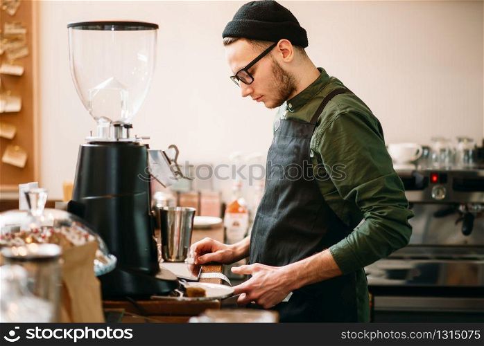 Barman making check in cafe. Blur background. Barman making check in cafe