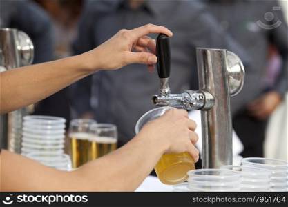 Barman pouring a beer