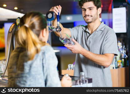 barman serving beer to woman at nightclub