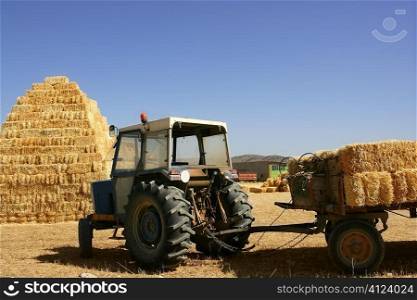 Barn stacked with piramyd shape and agriculture tractor vehicle
