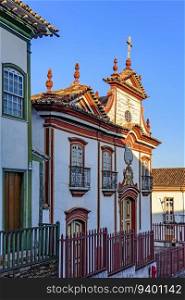 Baroque church facade and colonial houses in the city of Diamantina in Minas Gerais. Baroque church facade and colonial houses