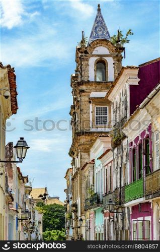 Baroque church tower emerging from among the old houses in the historic neighborhood of Pelourinho in Salvador, Bahia. Baroque church tower and old houses in neighborhood of Pelourinho