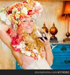 baroque fashion blond womand drinking red wine in grunge house
