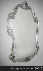 baroque silver mirror over white wall