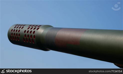 Barrel of artillery gun on the blue sky background