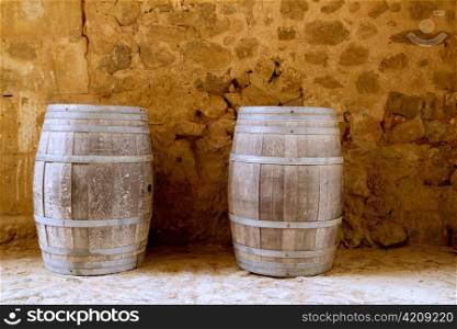 barrels of wine built in oak wood from Spain on stone masonry wall