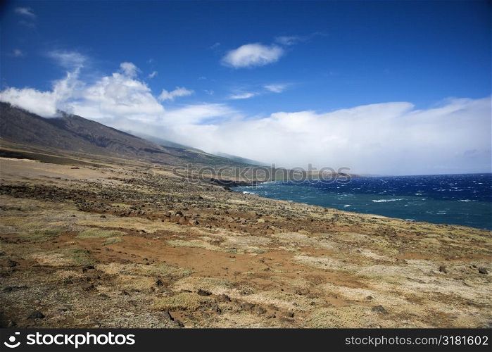 Barren landscape leading to Pacific ocean in Maui, Hawaii.