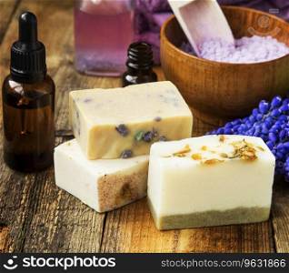 Bars of natural handmade soaps with floral extracts on spa setting and wooden background