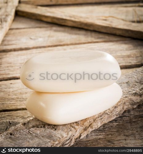 Bars of soap on a rustic wooden background