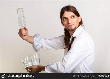 Bartender fills glass from bottle.. Drinking party liquor flair bartending concept. Bartender fills glass from bottle. Male tapster pours alcohol into glass.