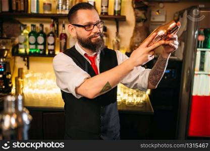 Bartender flair with shaker behind a bar counter. Barman flairing