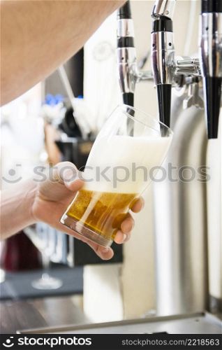 bartender pouring fresh beer pub