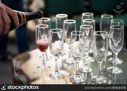 bartender pours ch&agne into a glass