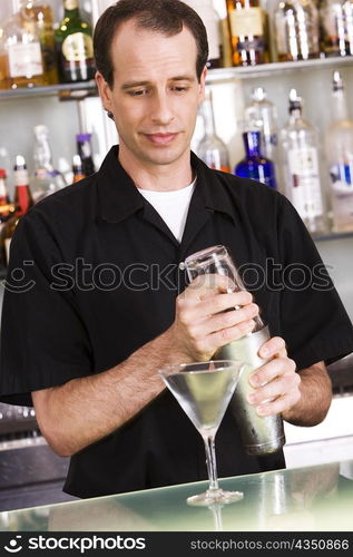 Bartender preparing a martini