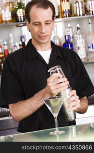 Bartender preparing a martini