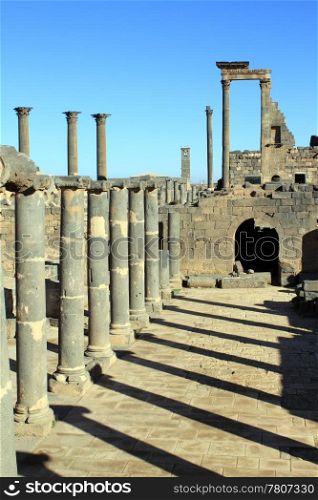 Basalt columns and shadow in ruins of Old Bosra, Syria