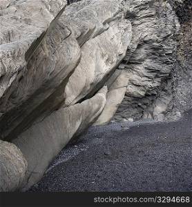 Basalt rock formation cave over sand