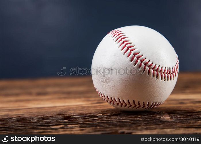 Baseball ball on wooden table. Baseball ball on wooden table and blue backgdound
