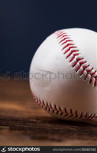 Baseball ball on wooden table. Baseball ball on wooden table and blue backgdound