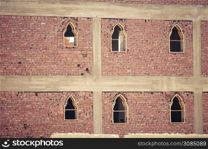 basic brick construction of house in North africa with window frames set