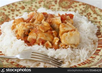 Basic fish curry, in a spicy tomato and coconut milk sauce, served on a bed of basmati rice.