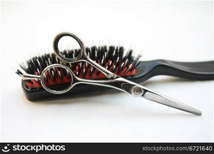 Basic hairdressers tools: pair of scissors and a brush