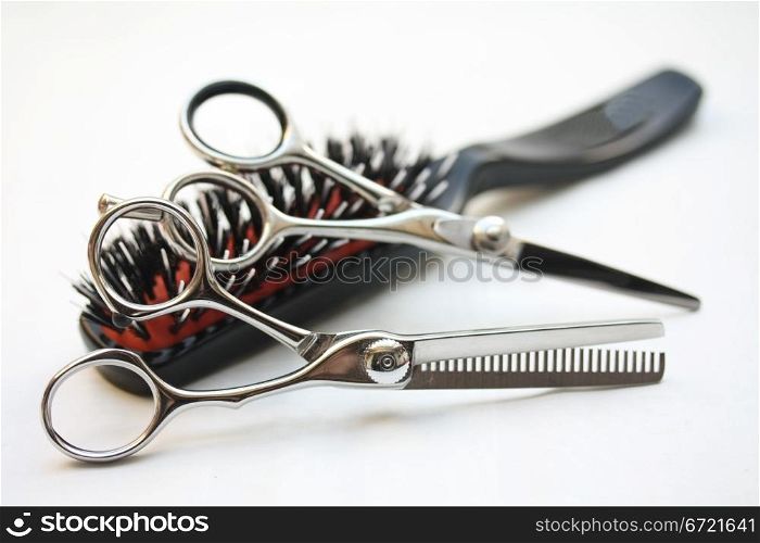 Basic hairdressers tools: two pairs of scissors and a brush