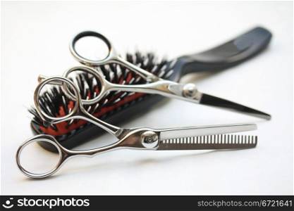 Basic hairdressers tools: two pairs of scissors and a brush