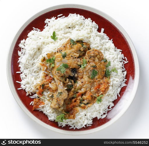 Basic homemade balti chicken on a bed of white basmati rice, seen from above